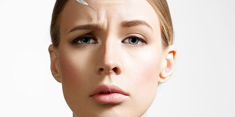 Close-up,Of,A,Beautiful,Woman,Making,Botox,Injection,On,White