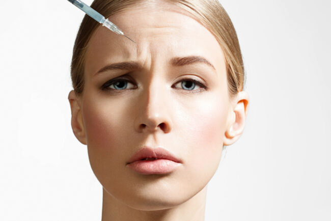 Close-up,Of,A,Beautiful,Woman,Making,Botox,Injection,On,White